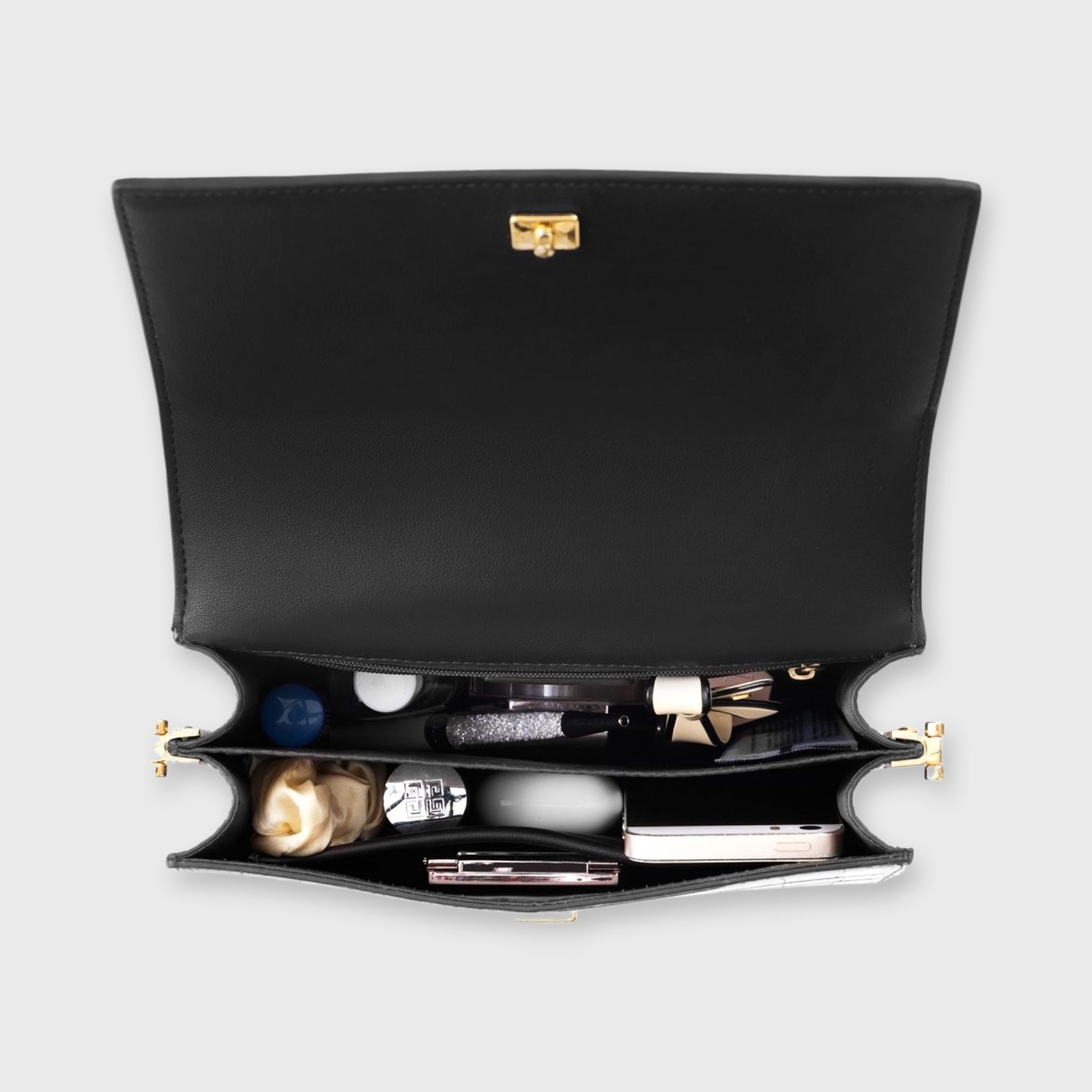 Black crocodile-print shoulder bag interior contents view