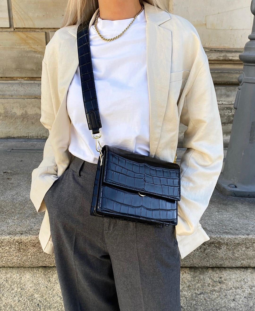 Black crocodile-print shoulder bag worn with outfit