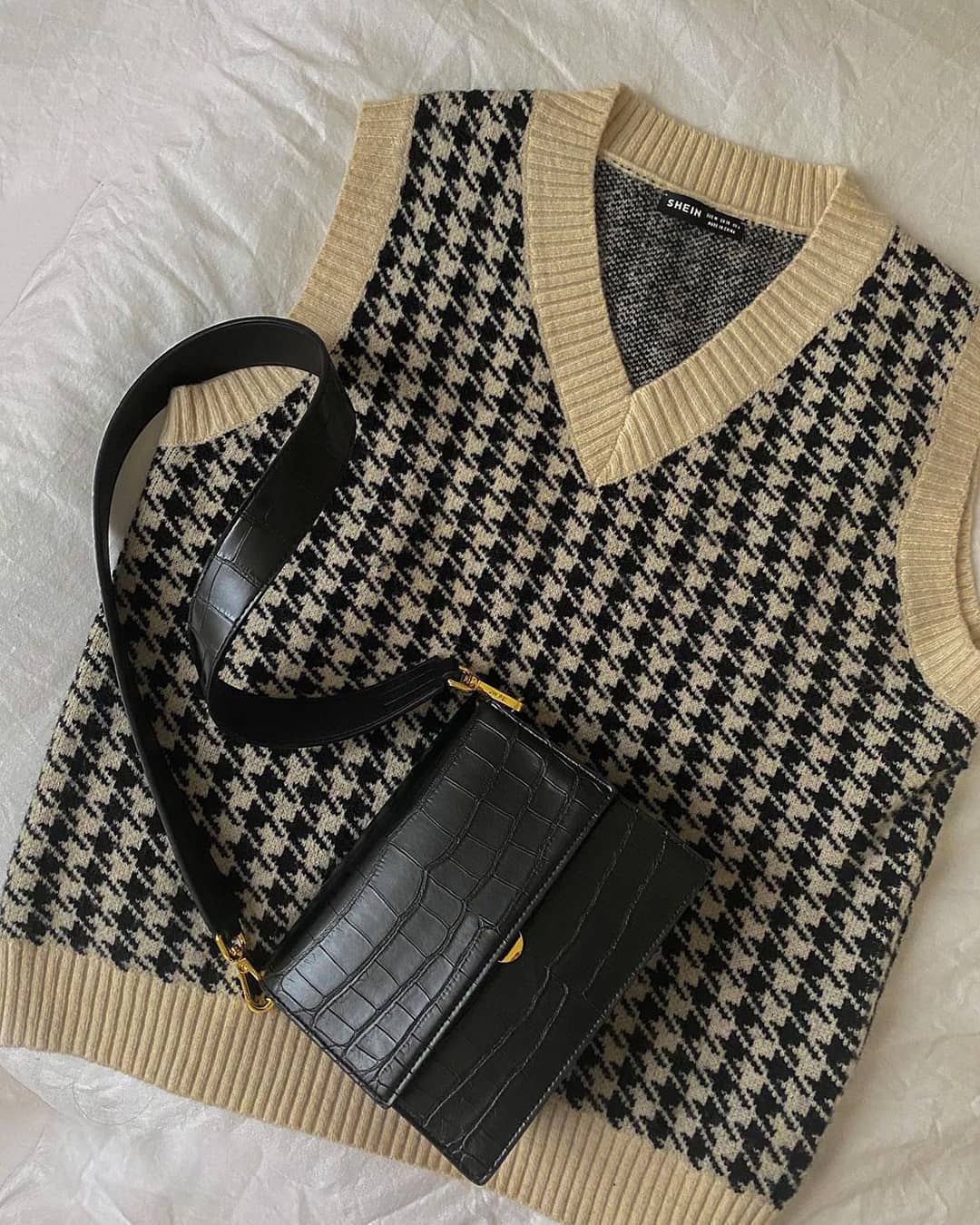 Black crocodile-print shoulder bag styled with sweater