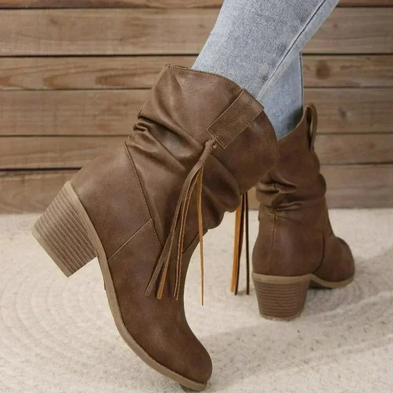 Brown western slouchy boots with braided tassels and stacked heel.