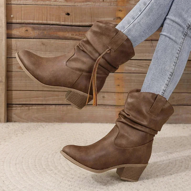 Brown western slouchy boots with braided tassels and stacked heel.