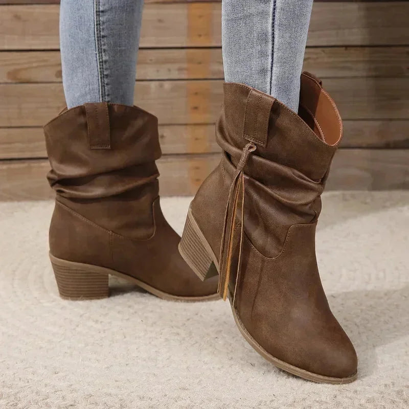 Brown western slouchy boots with braided tassels and a stacked heel.