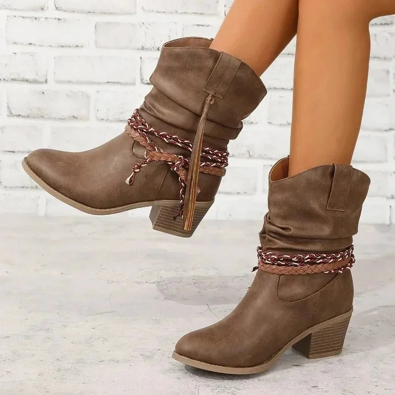 Brown western slouchy boots with braided tassels and stacked heel.