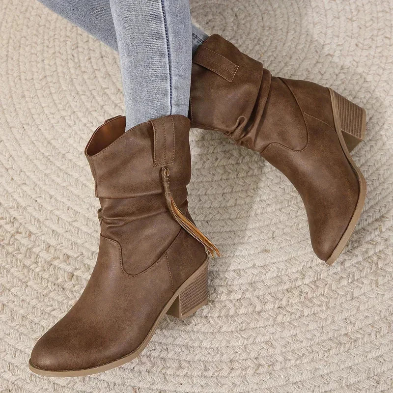 Women's dark brown western slouchy boots with braided tassels and stacked heel.